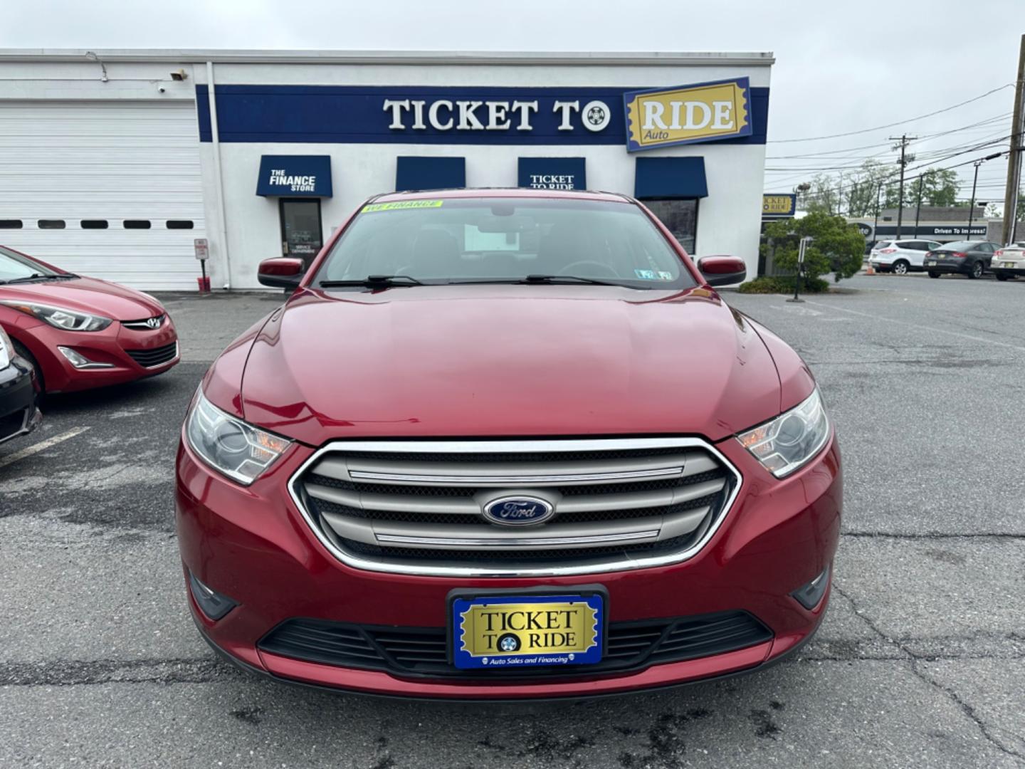 2013 RED Ford Taurus SEL FWD (1FAHP2E8XDG) with an 3.5L V6 DOHC 24V engine, 6-Speed Automatic transmission, located at 1254 Manheim Pike, Lancaster, PA, 17601, (717) 393-9133, 40.062870, -76.323273 - Photo#1